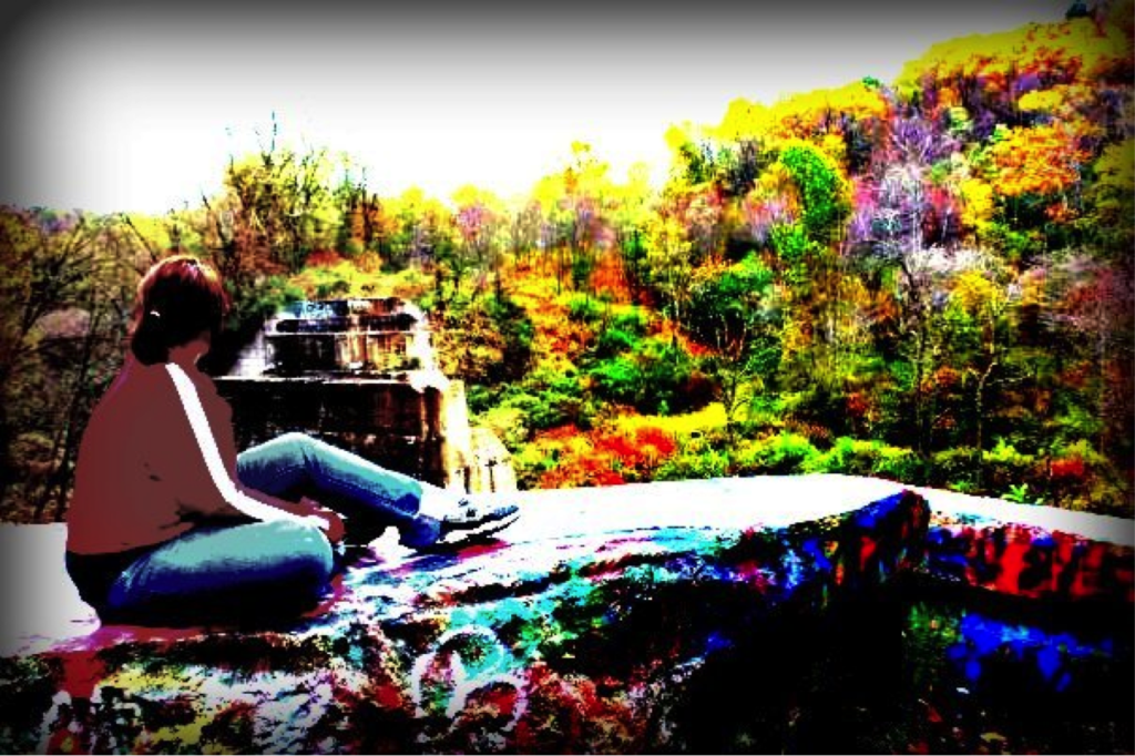 Same picture of Carly sitting on rock looking away from camera with colors distorted