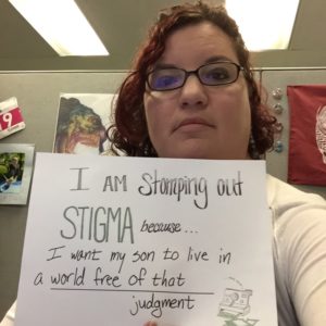 Kristen holding a sign: I am stomping out stigma because I want my son to live in a world free of that judgment